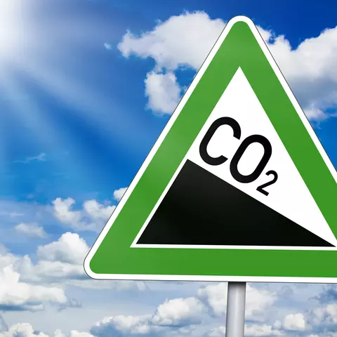 Road sign with decreasing CO2 emissions